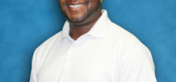 Smiling man in white polo shirt