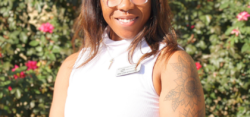 Smiling woman with arm tattoo in garden